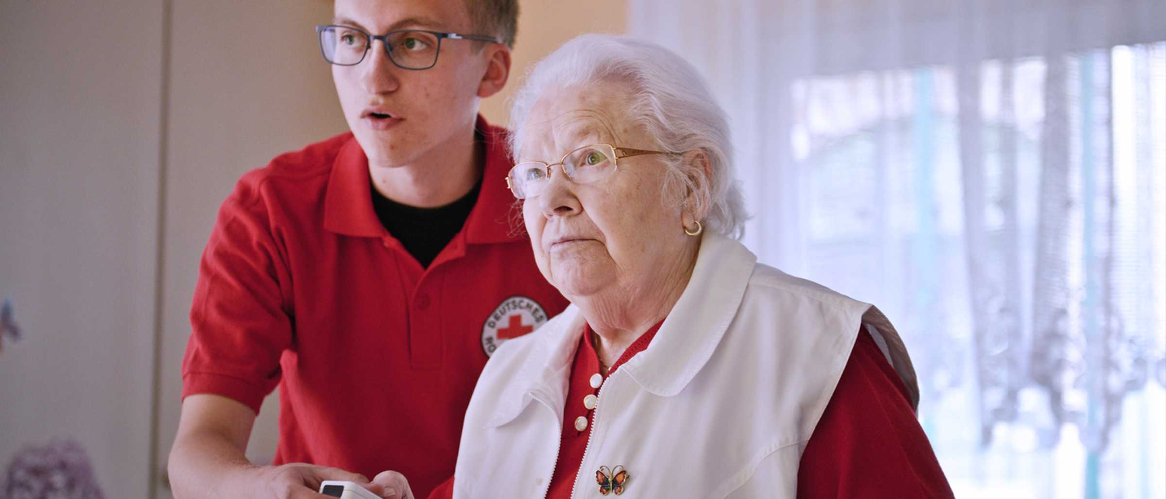 Clemens Brambach als FSJ'ler im FSJ freiwillig + digital, der auf dem Foto neben einer älteren Dame steht und gemeinsam mit ihr einen Nintendo Wii Controller festhält